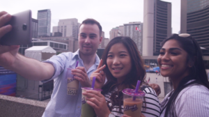 Three young people holding Chatime bubble tea in Toronto